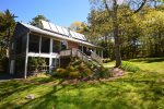 Back of house, passive solar panels and deck with grill